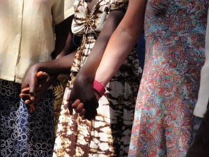 Justine holding her mama and her sponsored mamas hand